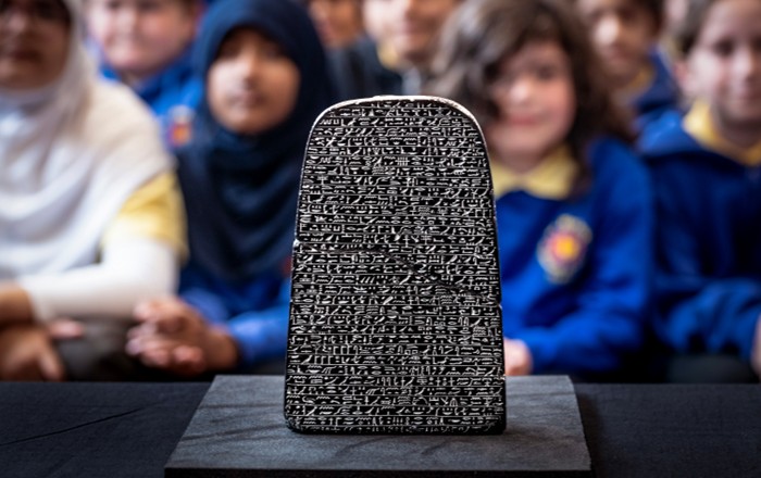 Children looking at the Egyptian stone
