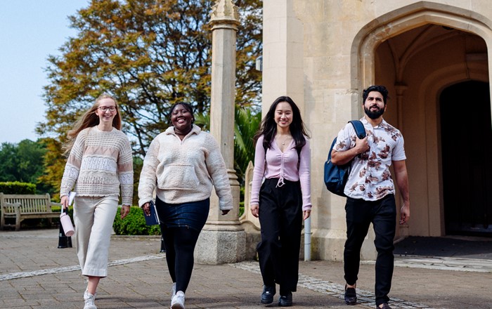 Four happy-looking students standing outside Singleton Abbey 