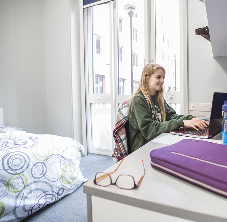 Student sitting in their room at the Emlyn hall