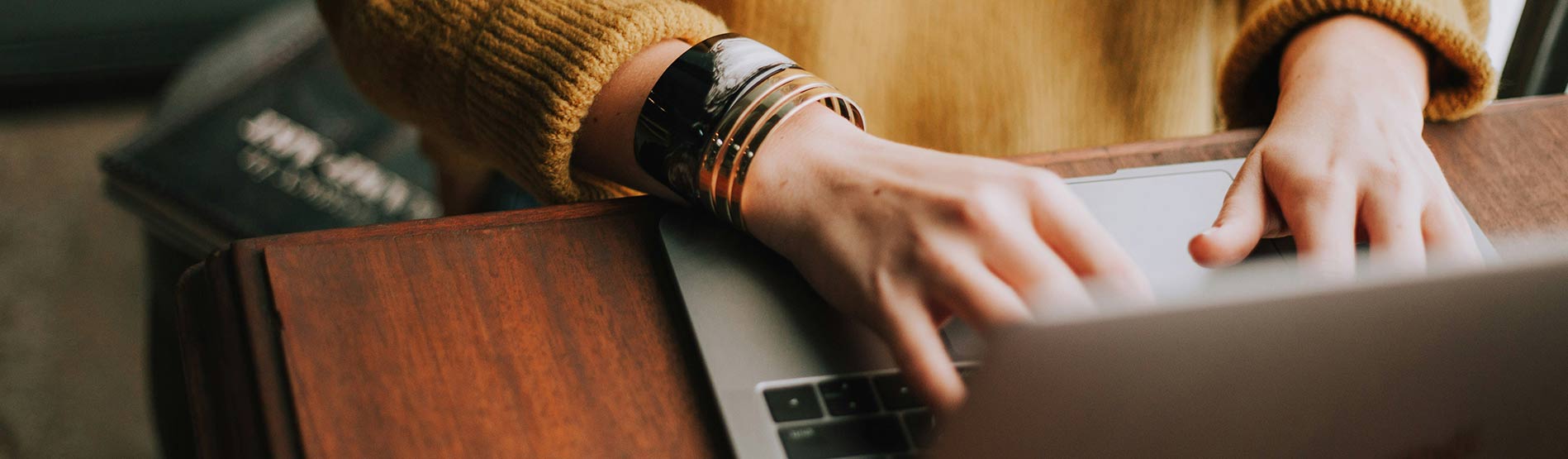 A person typing on their laptop.