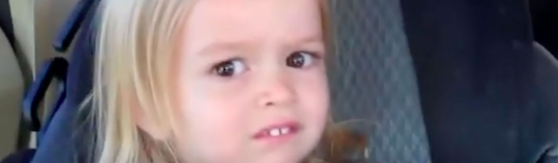 A popular meme showing a worried or concerned toddler in their car seat.