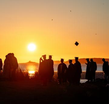 Students on the beach at graduation