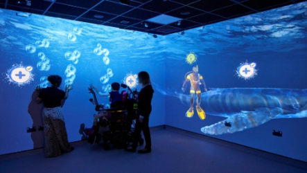 Immersive suite with visitors viewing an underwater scene