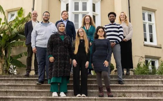 A group of Swansea University Sanctuary Students on the steps of Singleton Abbey