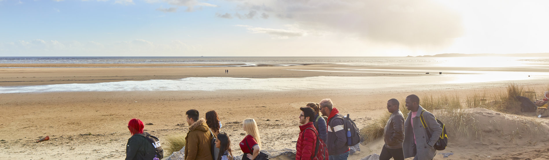 students walking on a beach