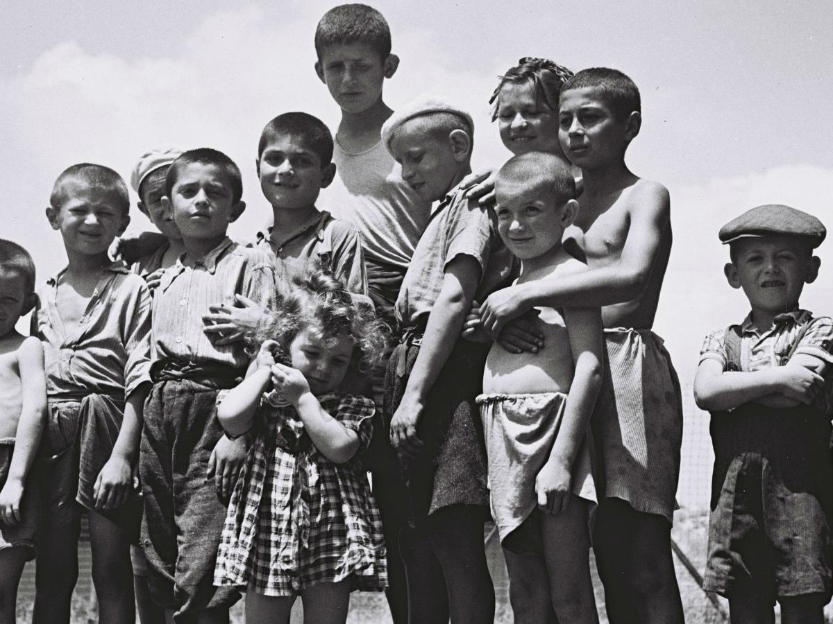 A number of orphans looking at the camera in grey scale. 