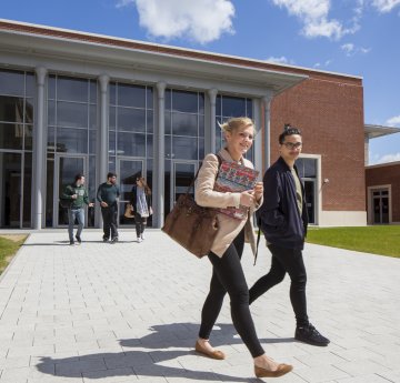 students walking out of the bay library