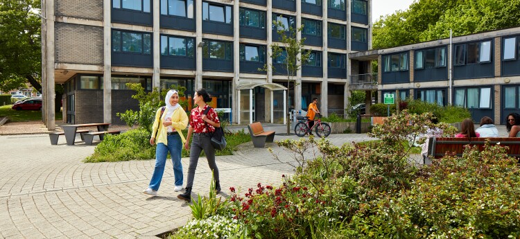 Swansea University campus with two students