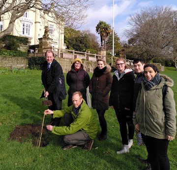 Ben Sampson planting a tree