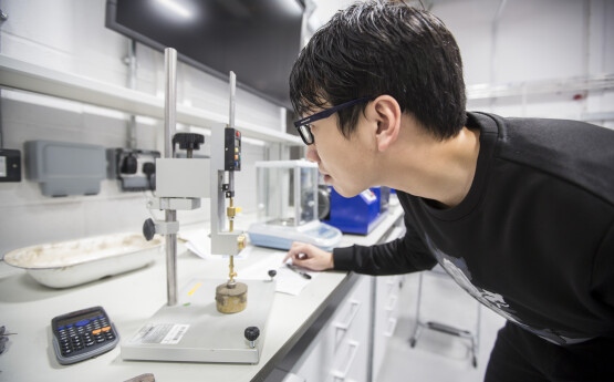 Student performing experiment in geomechanics lab