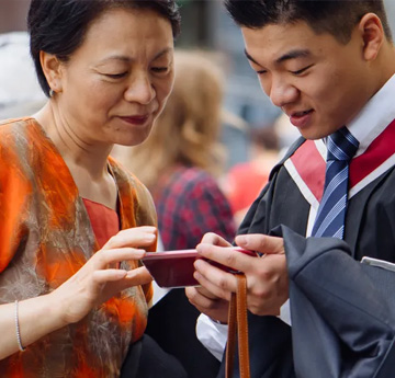 Mother and son looking at a phone together