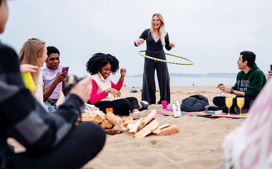 Students playing and chatting on the beach