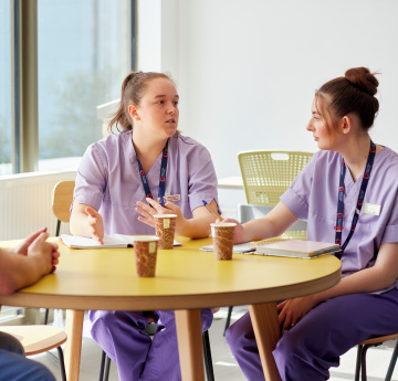 An image of two medical staff talking to each other. 