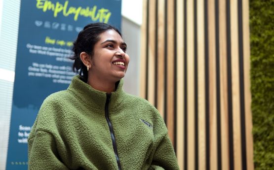 Student in front of an employability sign