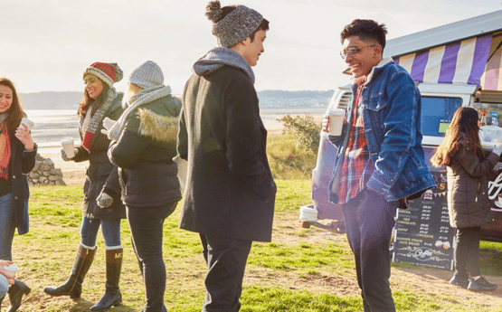 Students socialising near the beach.