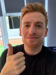 Selfie of man with thumb up.