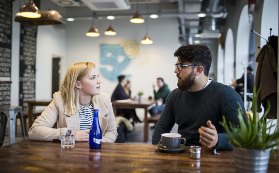 Two students having a drink. 