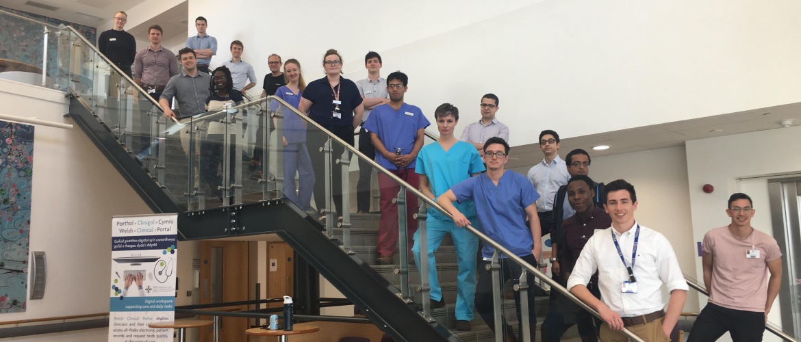 Final year cohort of medical students stood on a staircase.