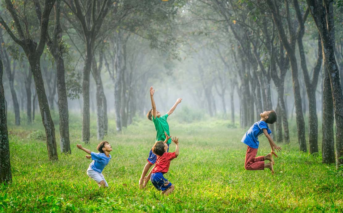 Image of children paying in the forest