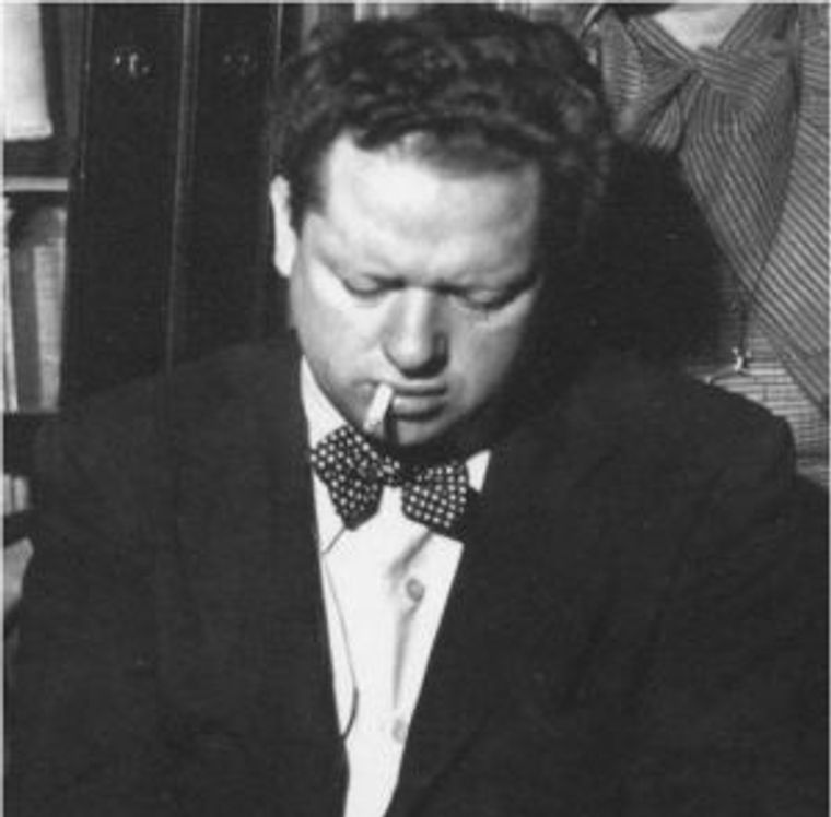 Shows Dylan Thomas smoking a cigarette. 