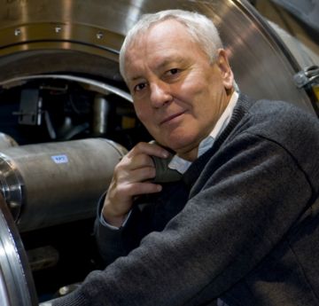 Man standing in front of a large hadron colllider 