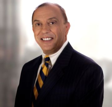 Man in a suit smiling at the camera