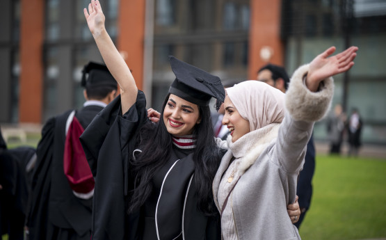 Two graduates celebrating