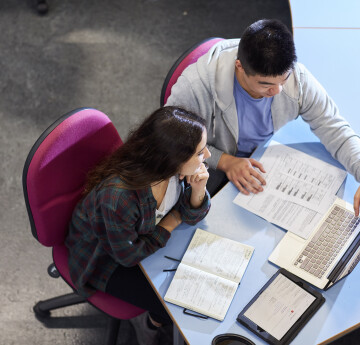 Female and male student using a laptop