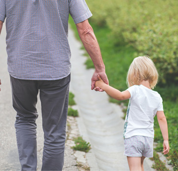 man walks with granddaughter