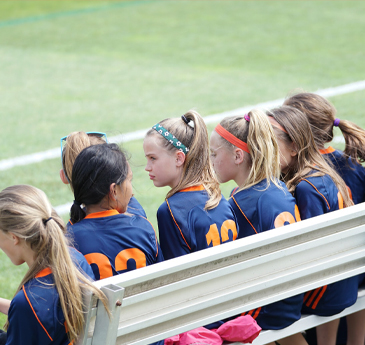 Girls waiting on a bench