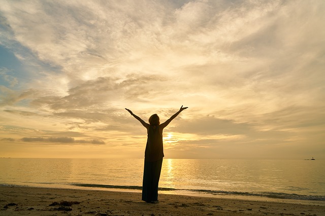 Person holding hands up to sky