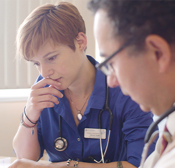 Two doctors studying paper