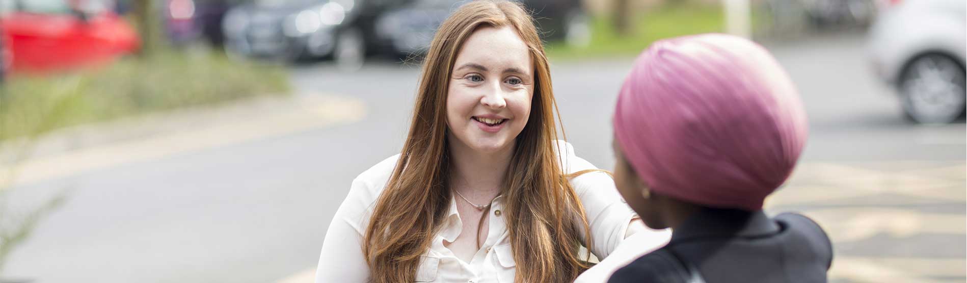 two students talking outside the Richard Price Building