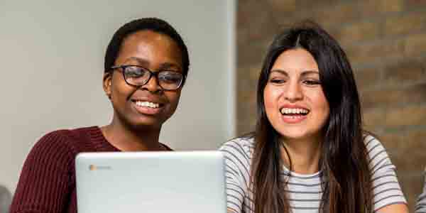 Students looking at a laptop 