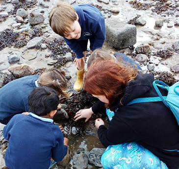 Children learning on a beach