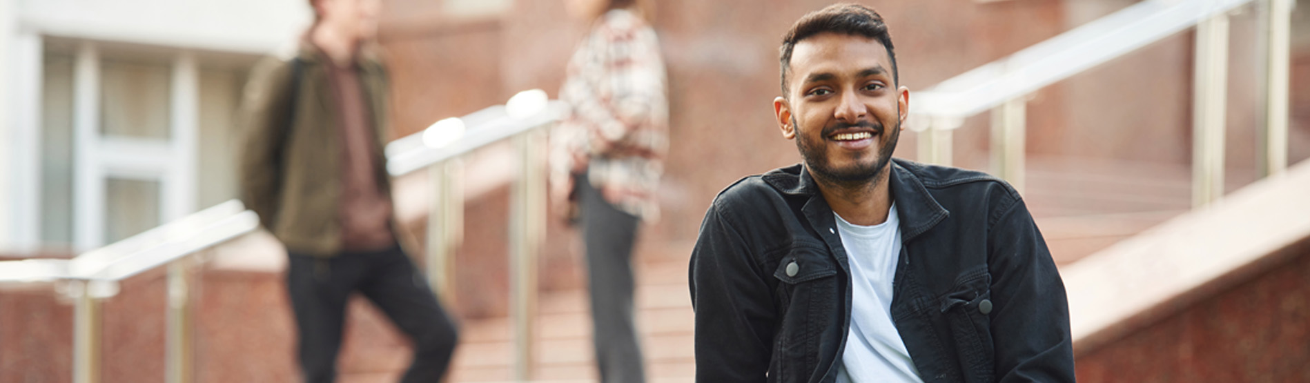 A student sitting on a wall