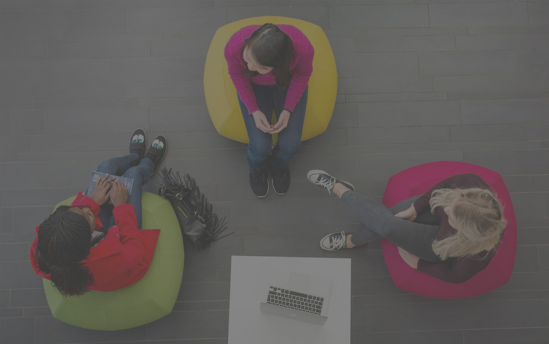 Three students studying as photographed from above