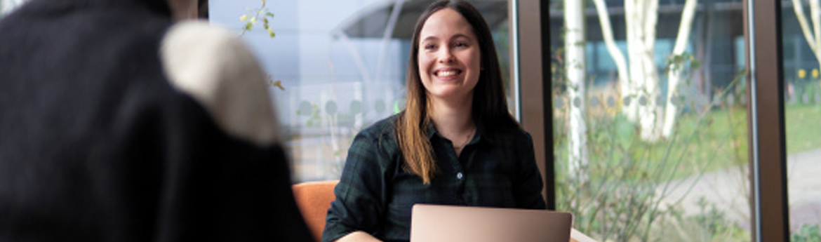 A woman typing on a laptop