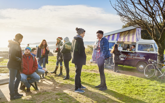 Students on the beachfront in front of campus