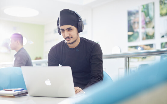 international student working on a laptop