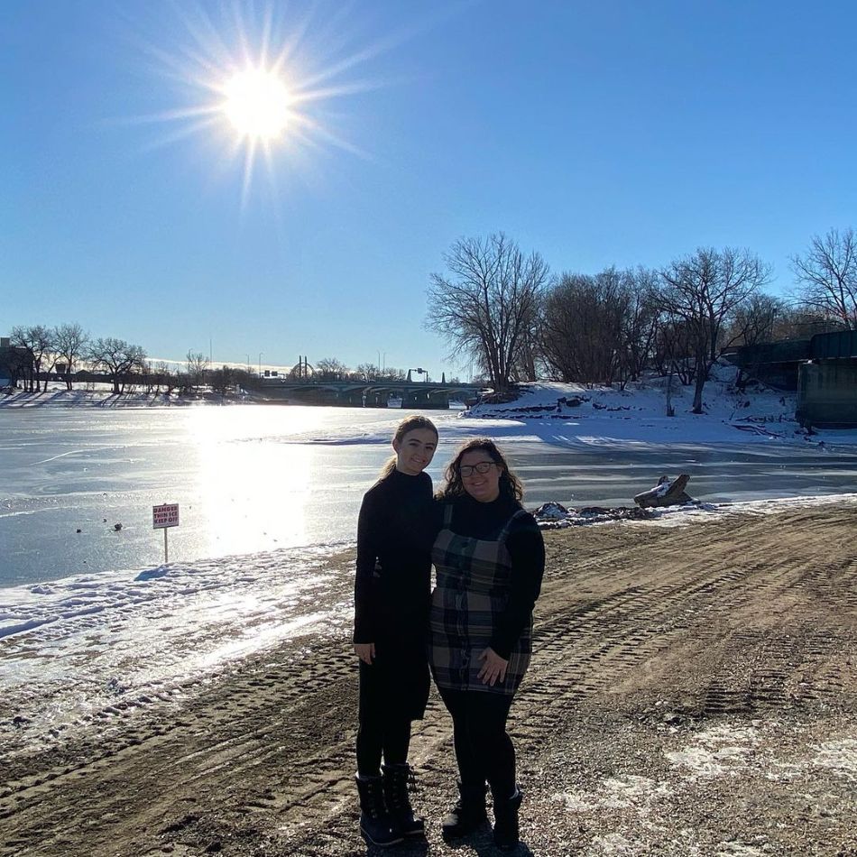 students in front of cold lake on sunny day