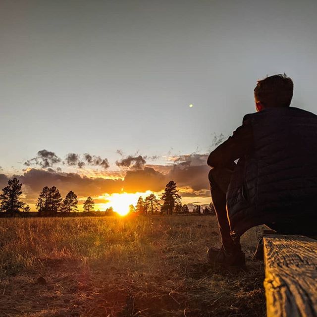 Sitting in front of sun set 