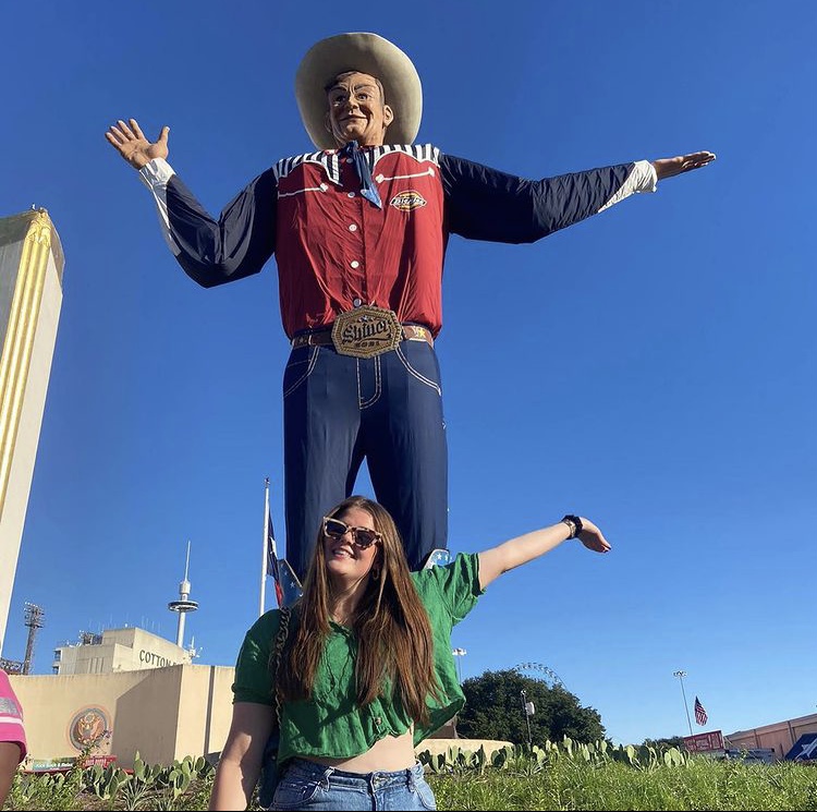 Student standing with a statue