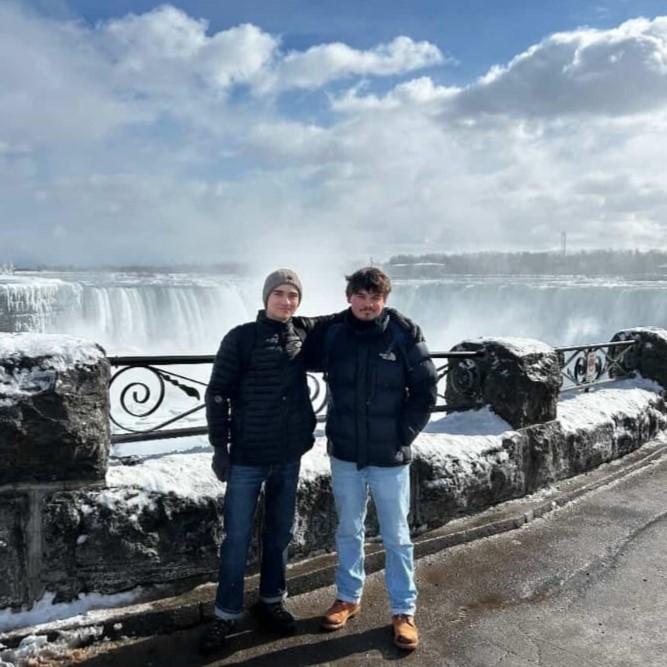 Friends standing in front of Niagra Falls 