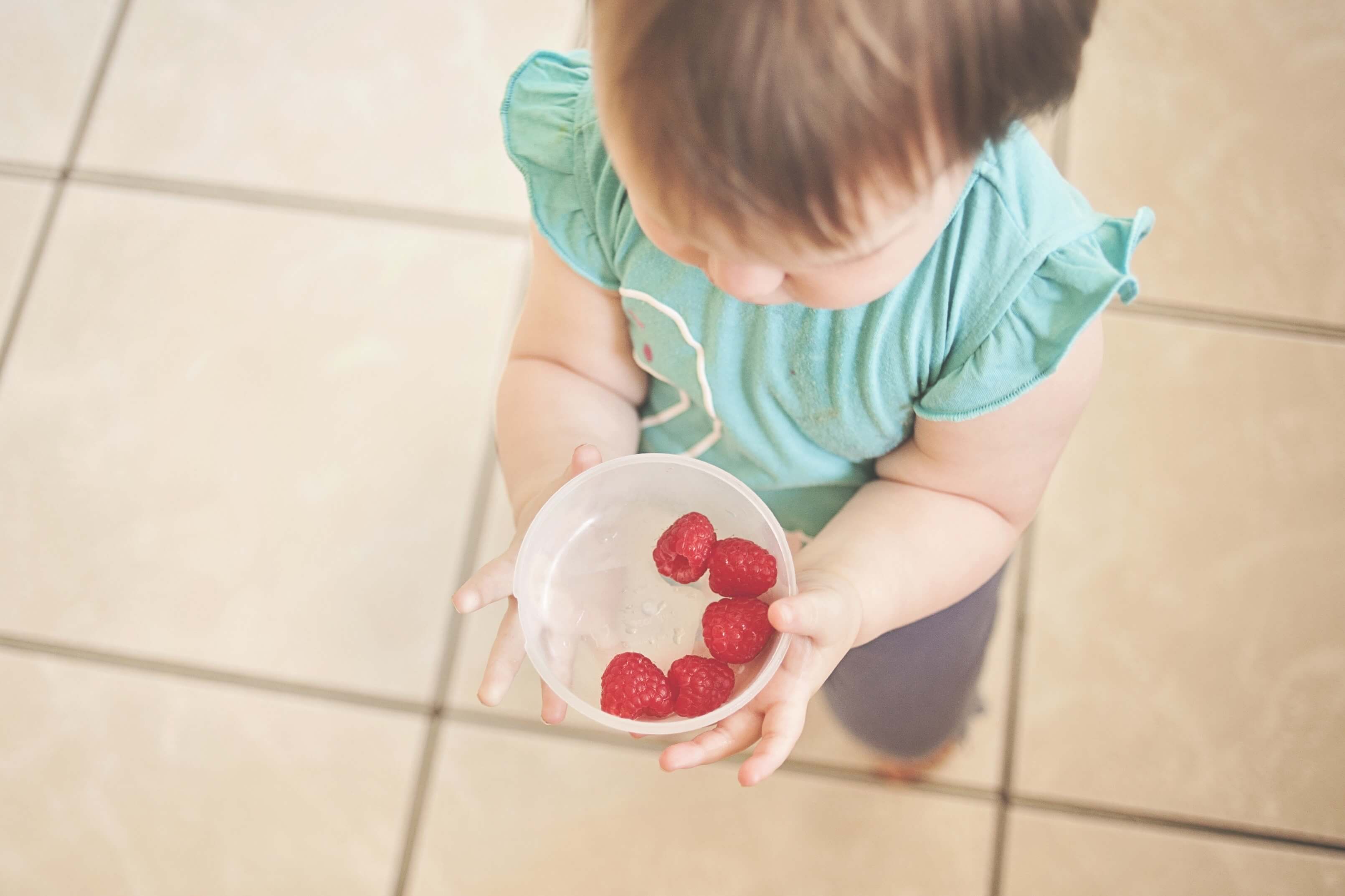 Baby with strawberries