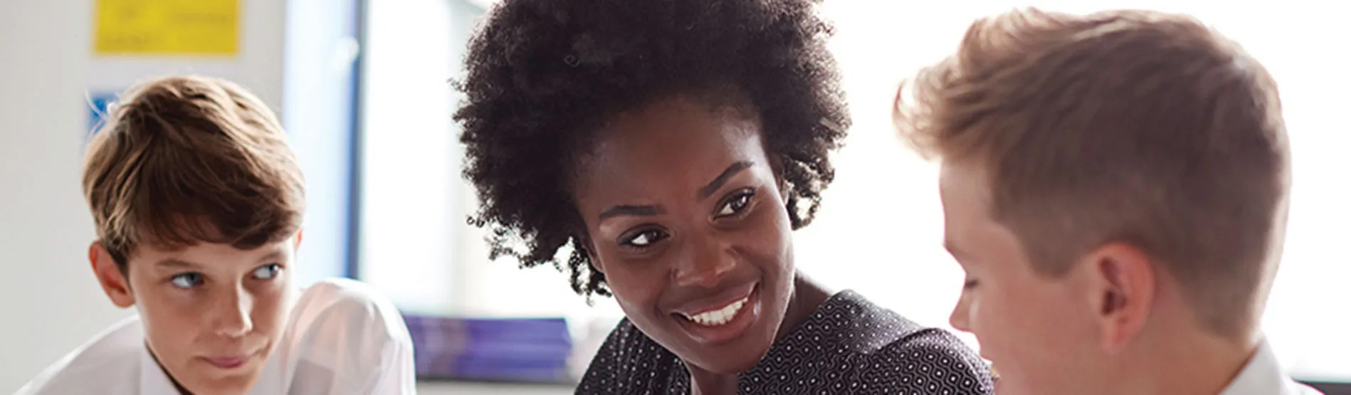 A teacher talking to two pupils