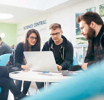 Three members of staff working in the university setting.