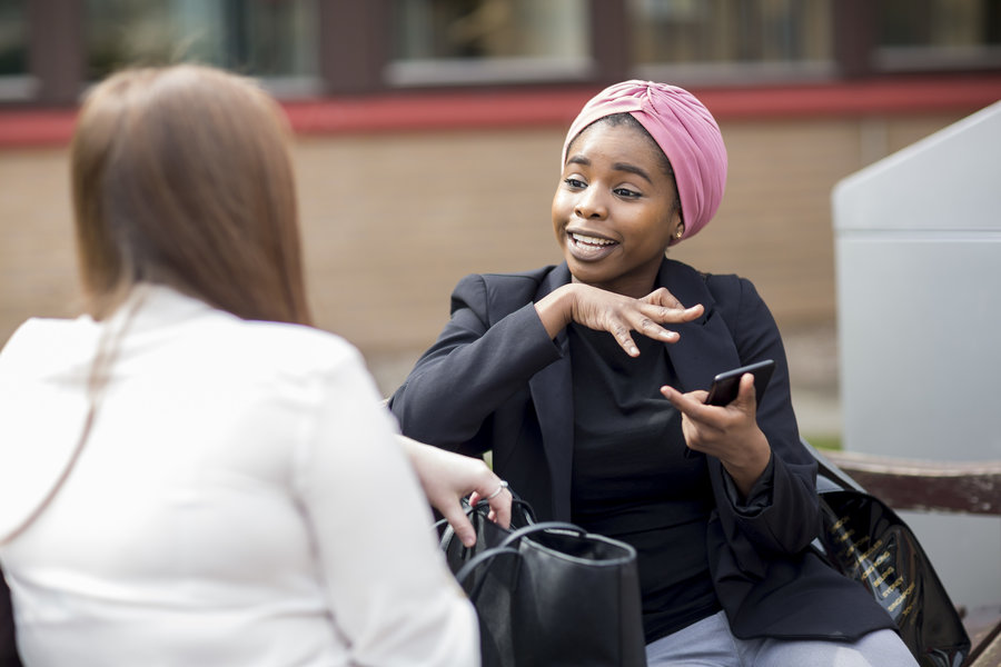 Image of two students talking.