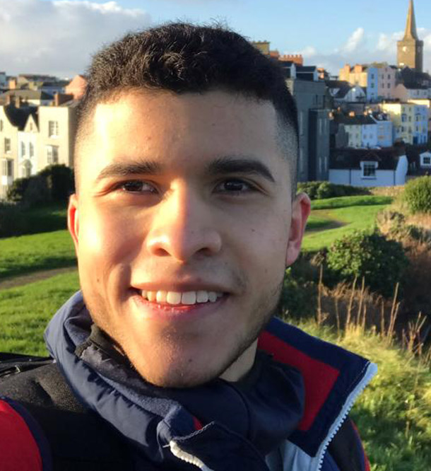 Smiling male student from Columbia in the sun in a rural environment 