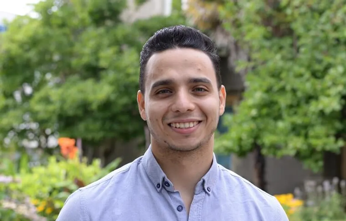 Male Egyptian student smiling at the camera.